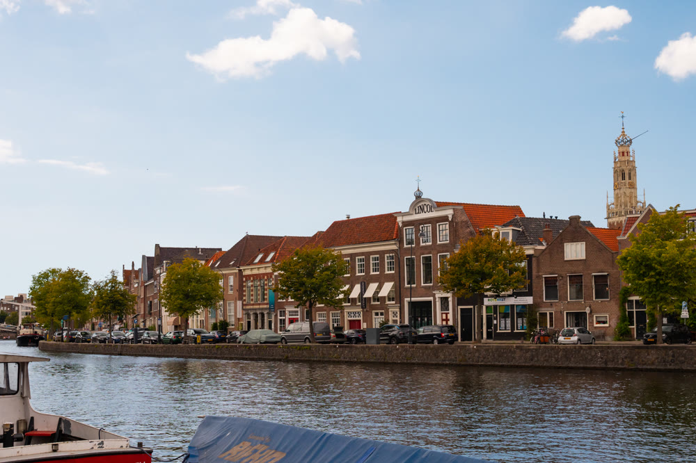 Haarlem embankment on Spaarne river with Bakenesserkerk bell tower in background