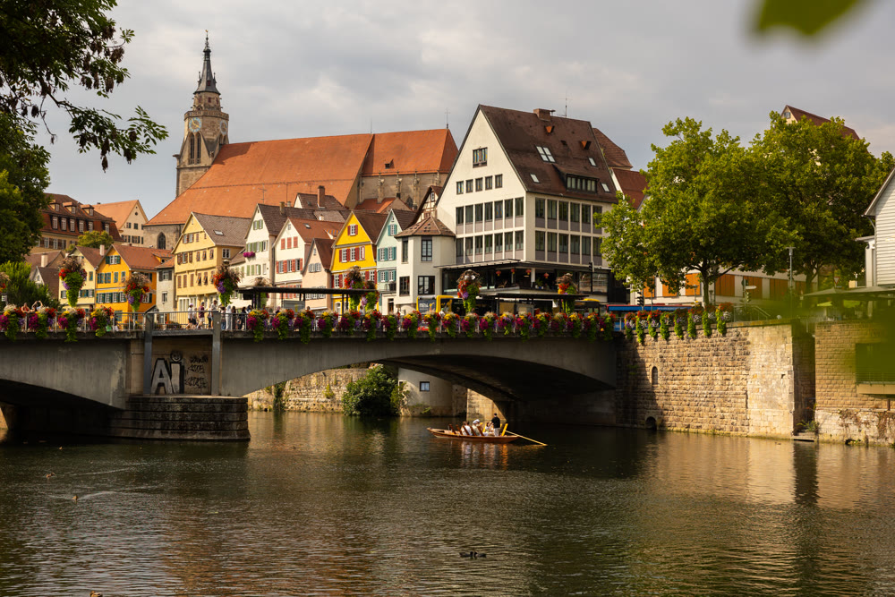 Neckar river waterfront with historic houses and Eberhardsbrucke bridge