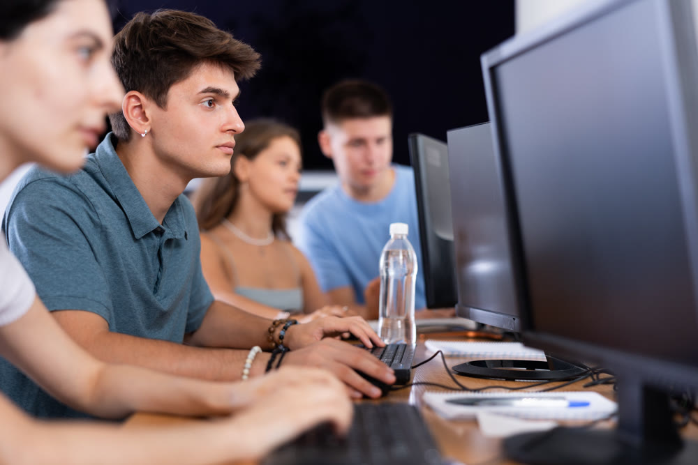 student sits near computer