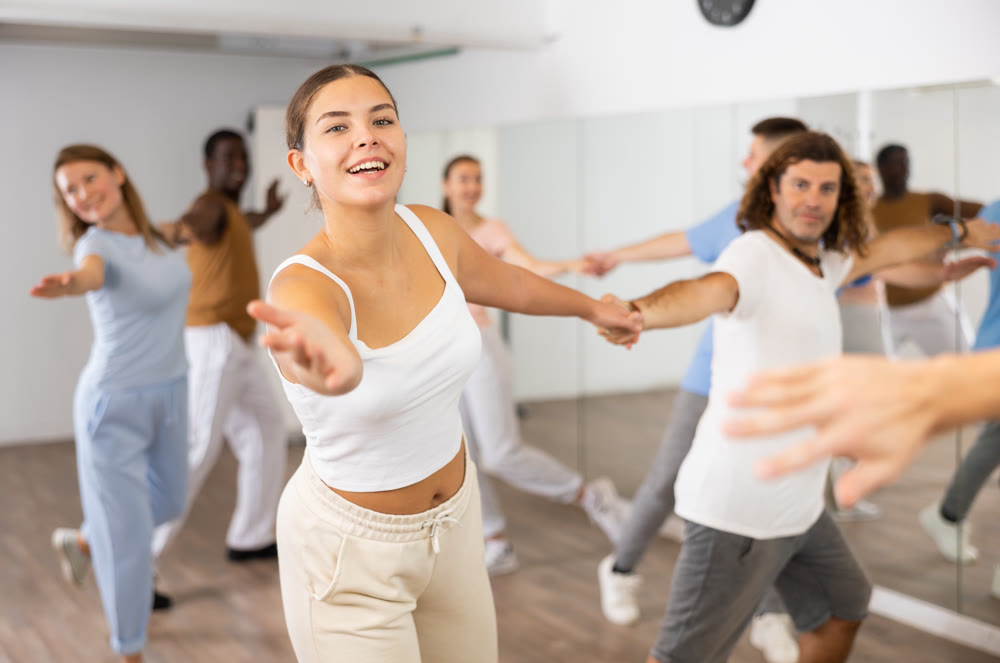 Adult couples dancing active dance together in studio