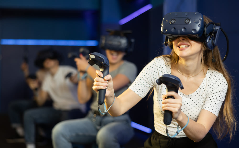 teenager in virtual reality glasses with joystick play survival game in tone jungle of future