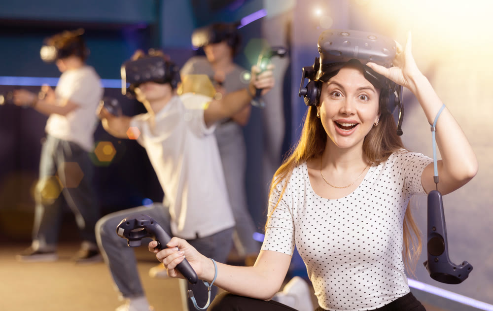 girl is exhilarated by turn of events in VR game and moved virtual reality glasses to forehead
