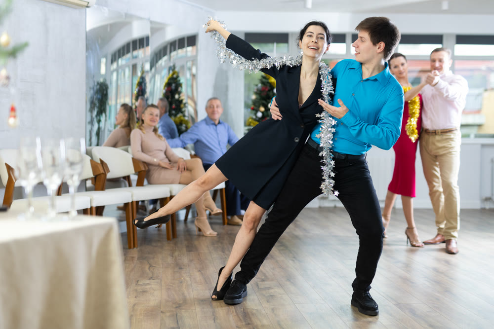Elegant couple performing support in dance at New Year celebration