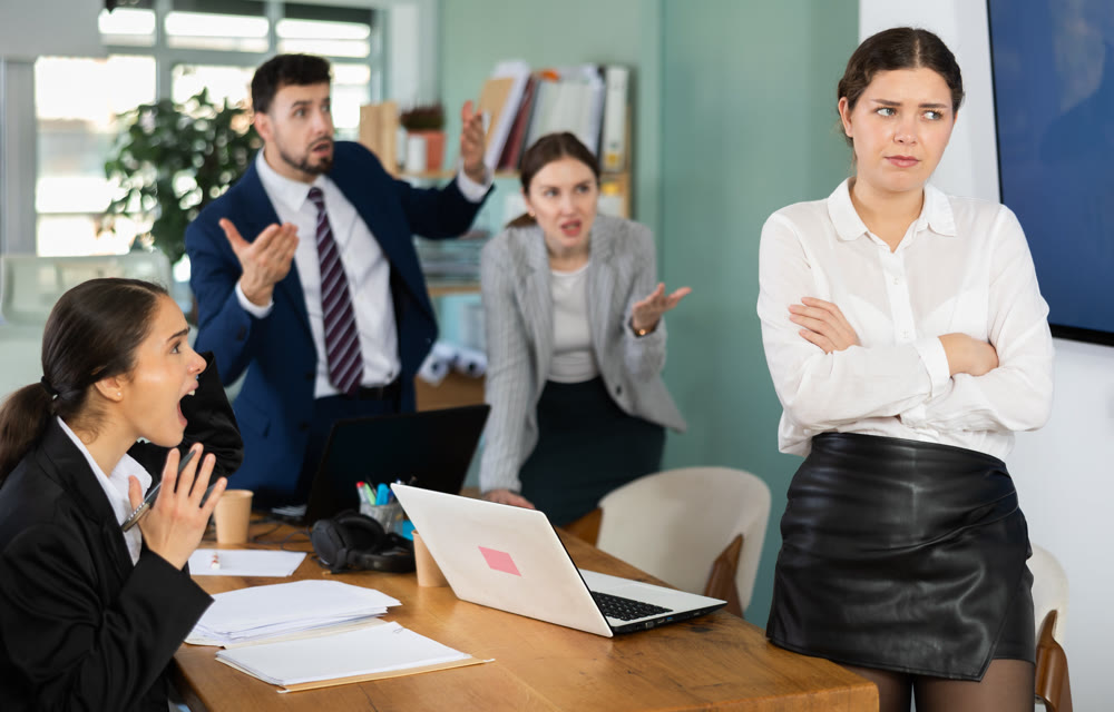 Angry office employees shout at a guilty employee who made mistakes in the project