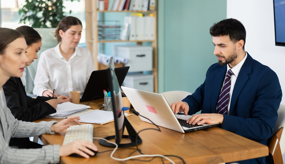 Male and female colleagues working in modern office