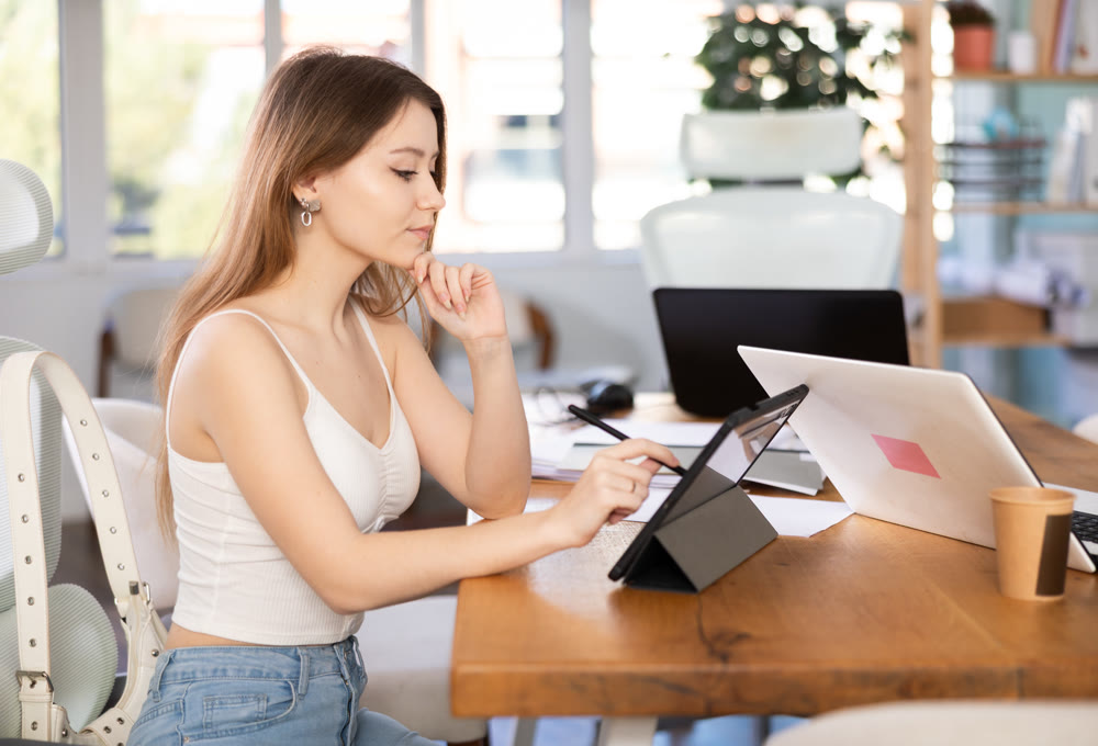 Young woman working on tablet in office