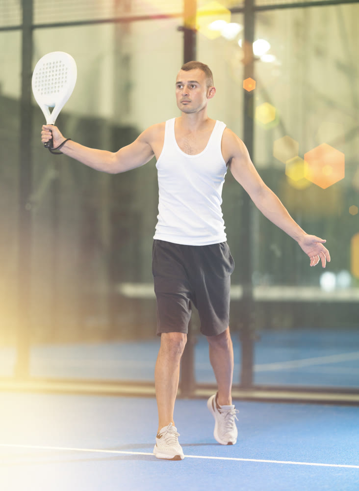 Young man making serve while playing tennis
