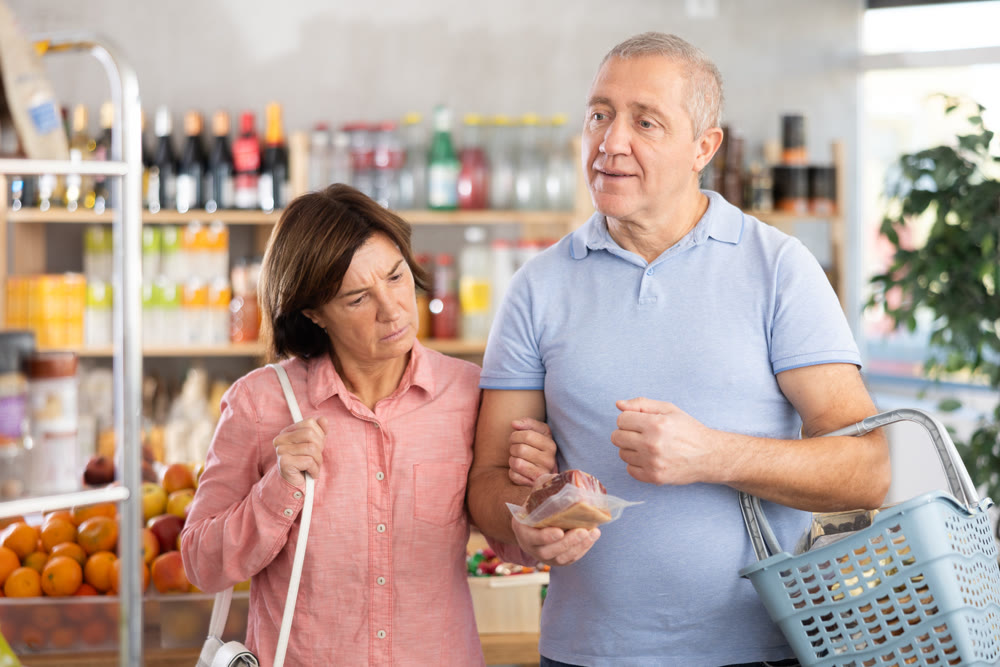 Senior family couple is looking for fresh produce together in grocery supermarket