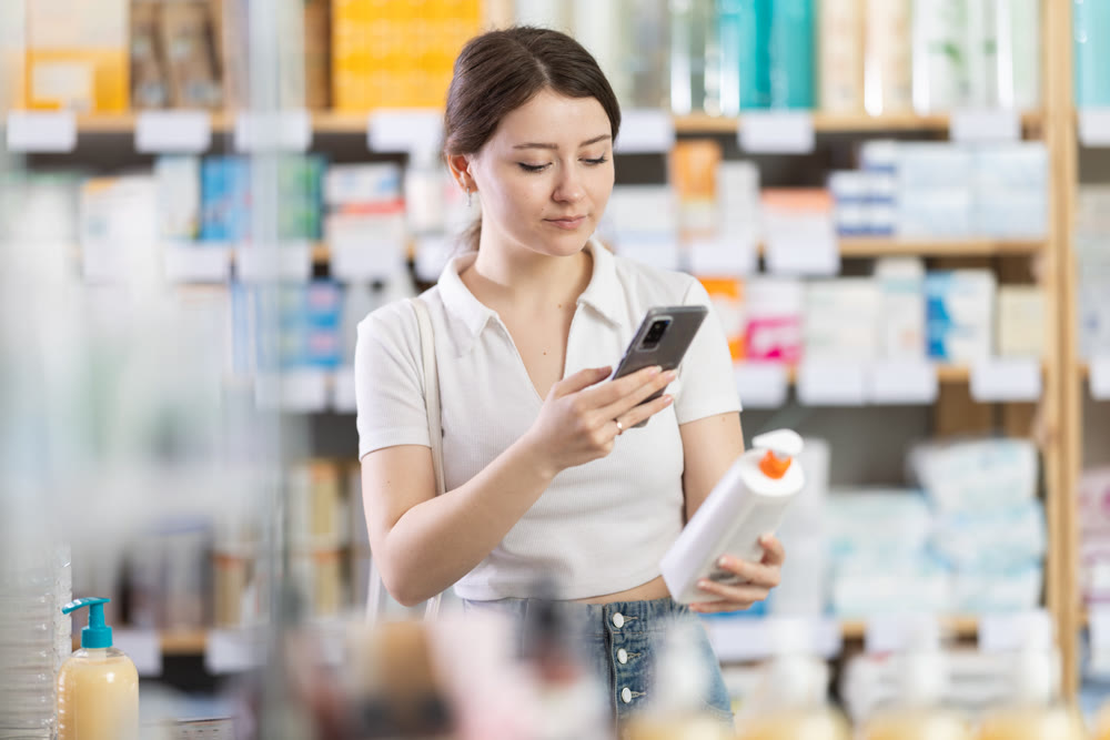 Woman scanning a package of cream