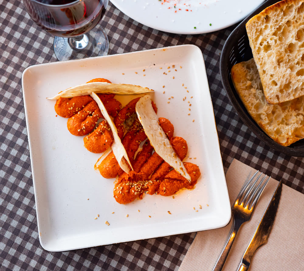 Spicy Muhammara dip from Aleppo pepper and walnuts with flatbread