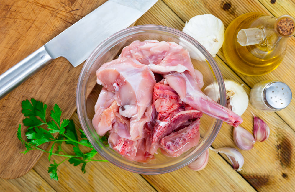 Raw rabbit meat with natural ingredients before cooking