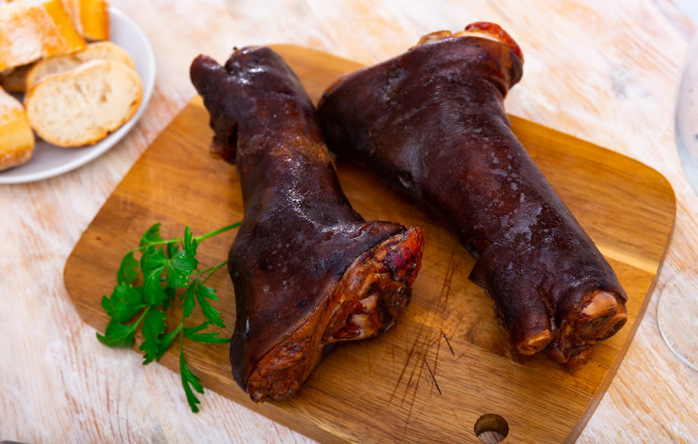 Romanian style roasted pork hock (knuckle, shank) with parsley on cutting board