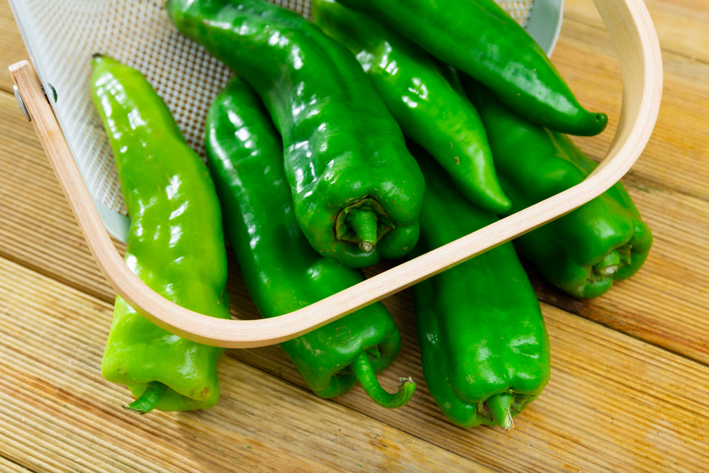 Green peppers on wooden table, cooking ingredients