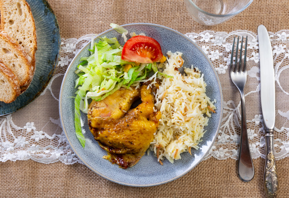 Delicious chicken dish with salad and rice
