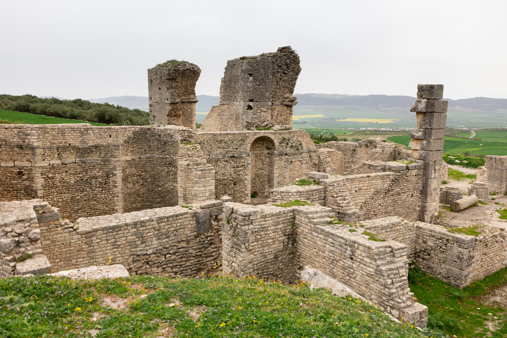 Ancient Roman baths of Licinius Sura amidst greenery in Dougga, Tunisia