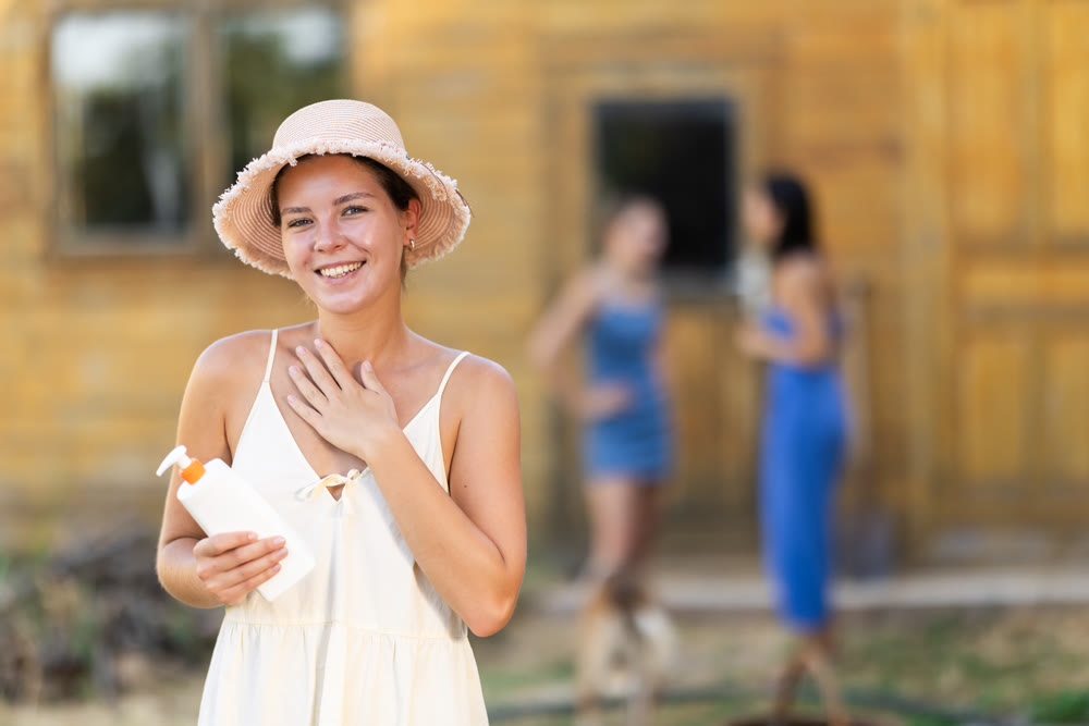 Female rural worker uses sunscreen