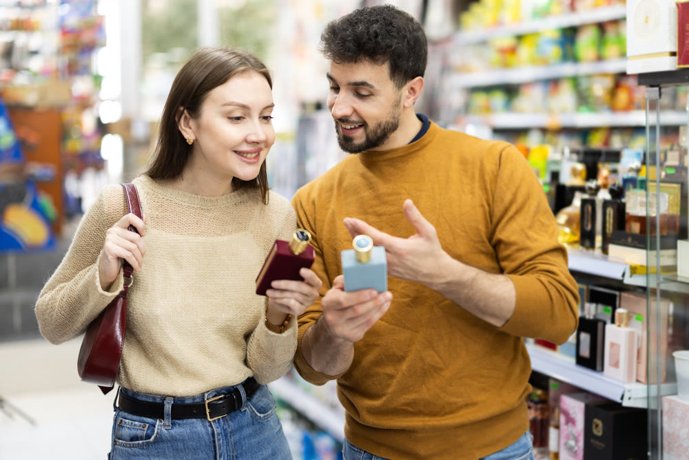 Couple spends time in store, looking for goods and select perfume