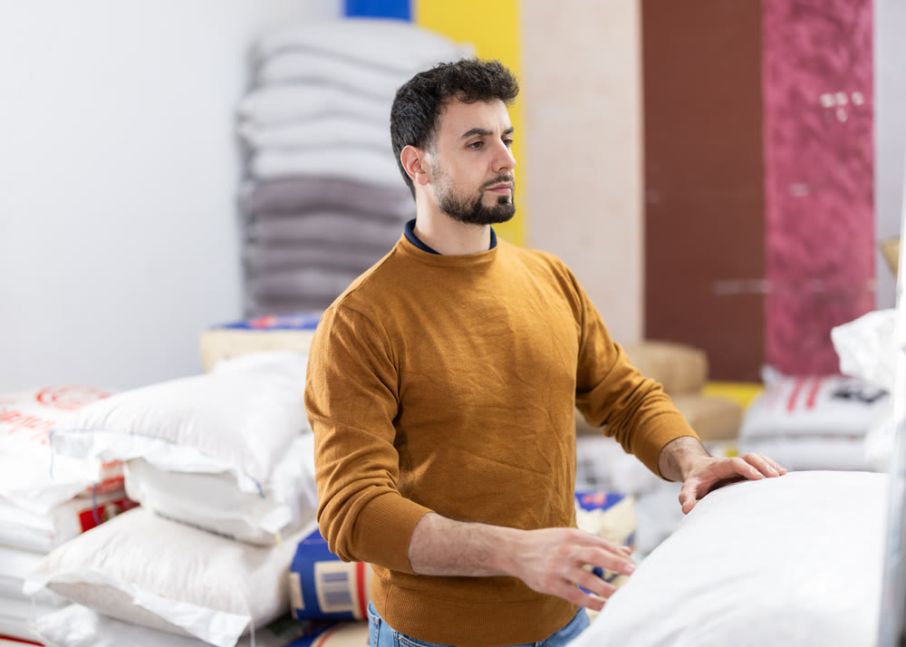 Worker loading sacks at warehouse store