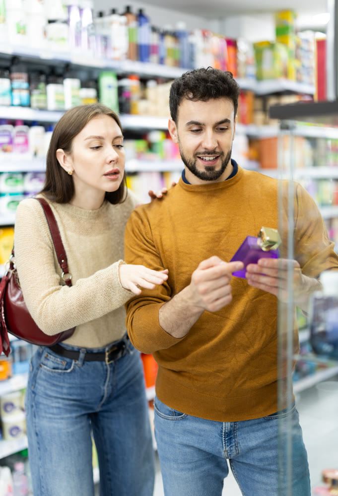 Young couple chooses perfume in store