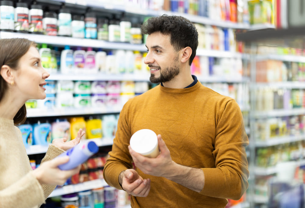 Couple spends time in store, looking for goods and select care product