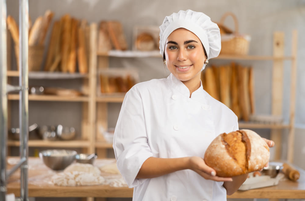 Young female baker with homemade bread