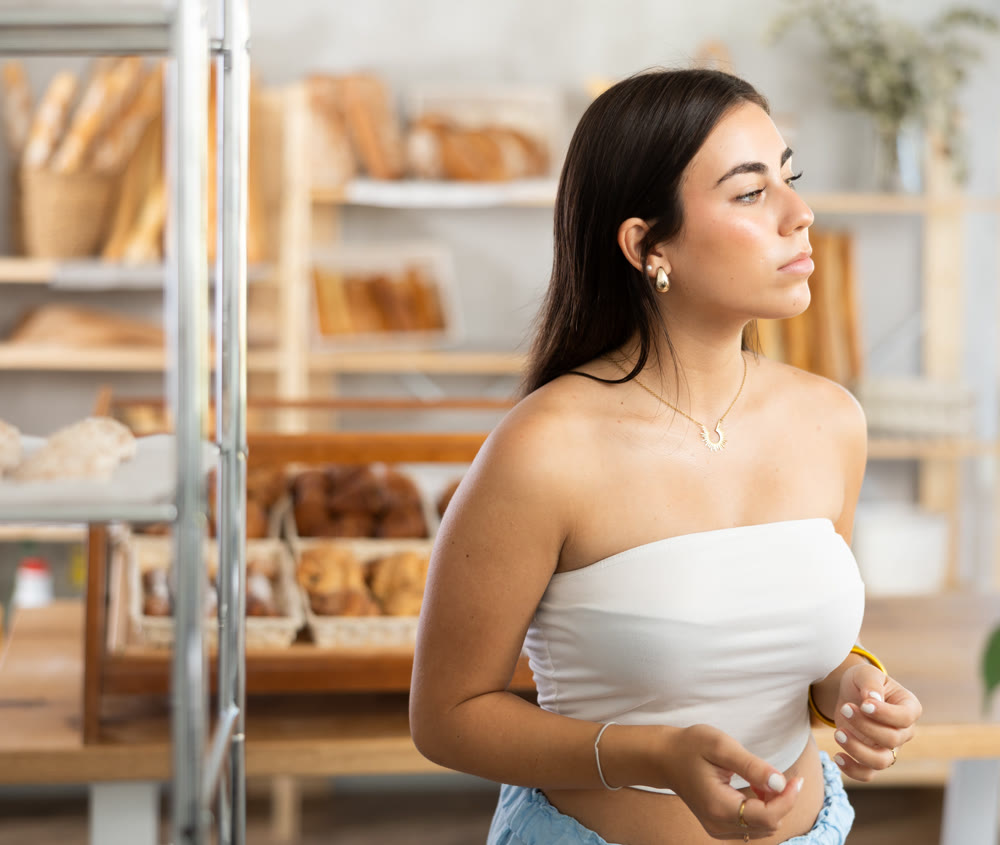 Young woman looking around in bakery