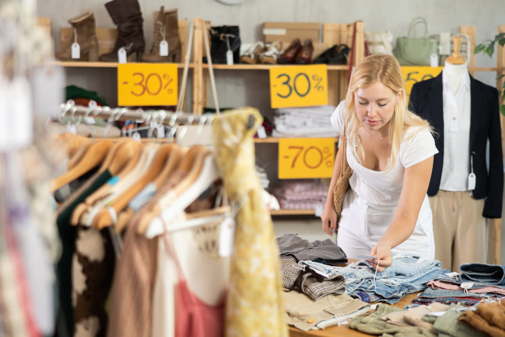 Woman chooses pants at discounts