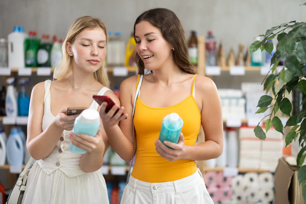 Girls friends buyer scans qr code on shampoo or shower gel label