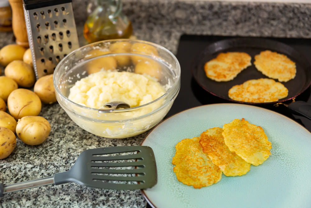 Frying potatoes pancakes during cooking in frying pan