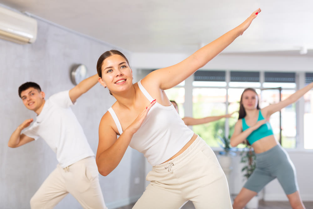 Group of teenagers dancing modern dance in ballroom