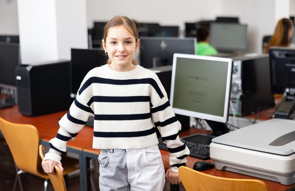 Portrait of schoolgirl girl in computer class at school