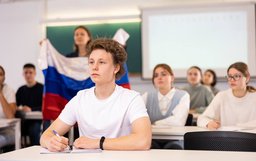 Young boy student studying diligently at school