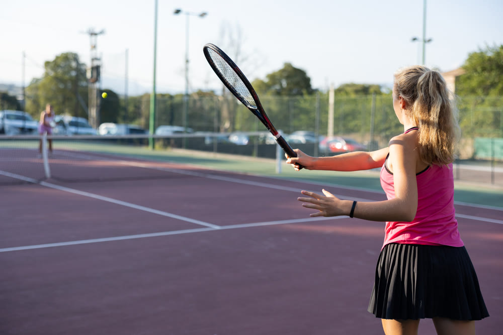 Woman tennis player training on court