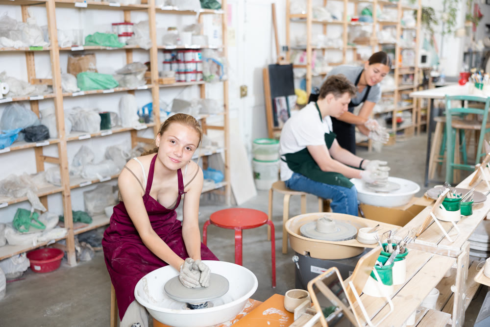 Girl teenager learns how to create pottery in workshop