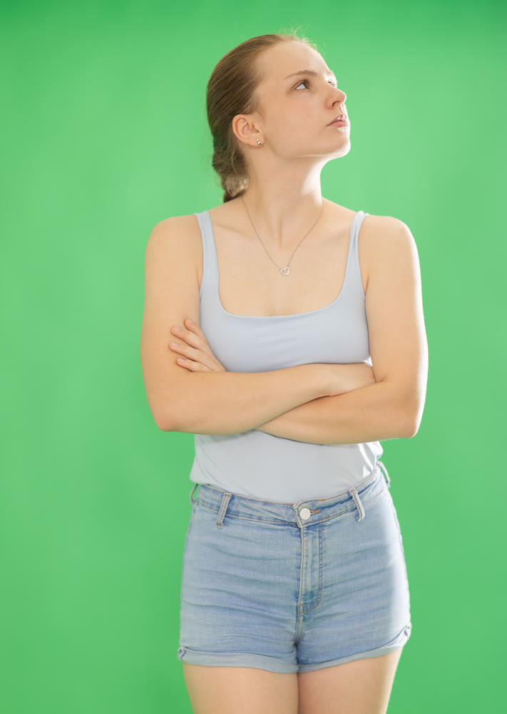 Sad teenage girl in front of green screen
