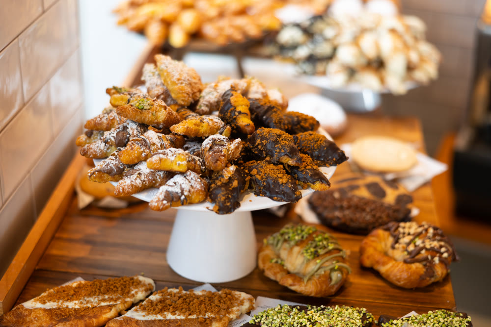 Fresh pastries on counter of bakery cafe