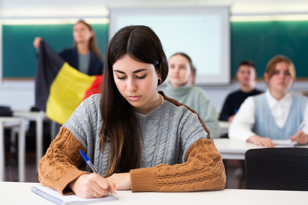 Young girl student diligently studies at school