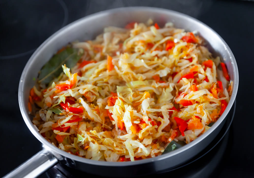 Spanish dish with cabbage and pepper for lunch in frying pan