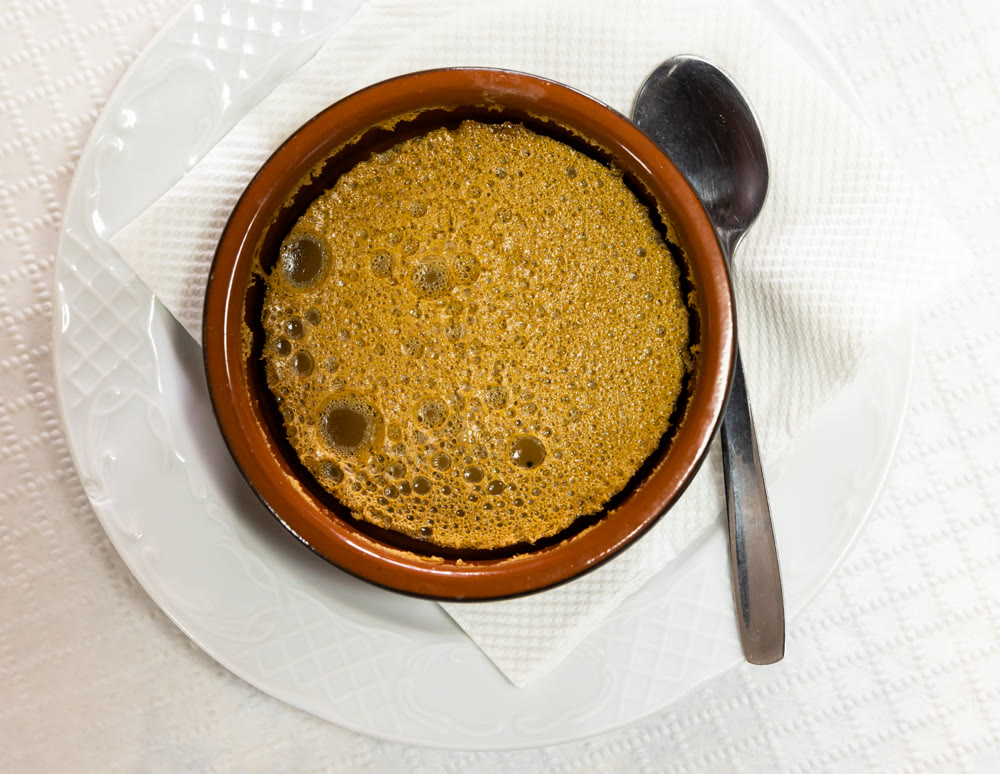 Sweet dessert honey mousse whipped to delicate foam is served in small glass for breakfast.