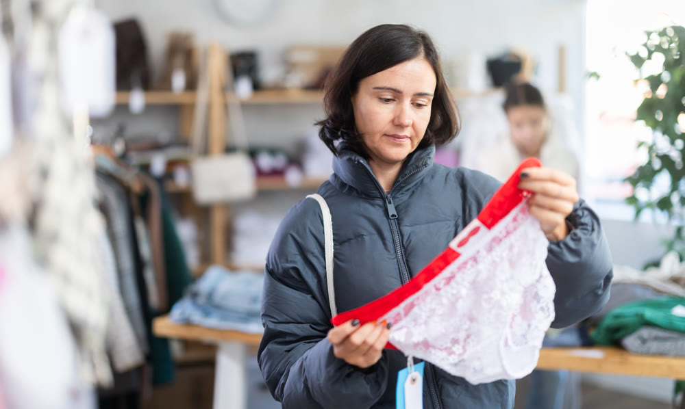 Adult woman chooses panties in clothing store