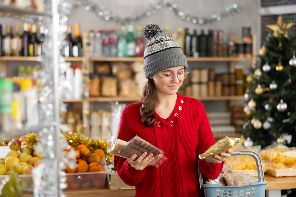Adolescence girl customer choose consider desserts and sweet snacks.
