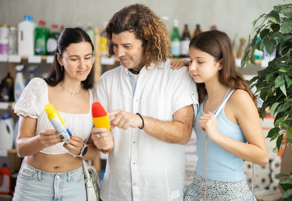 Family choosing repellent in supermarket