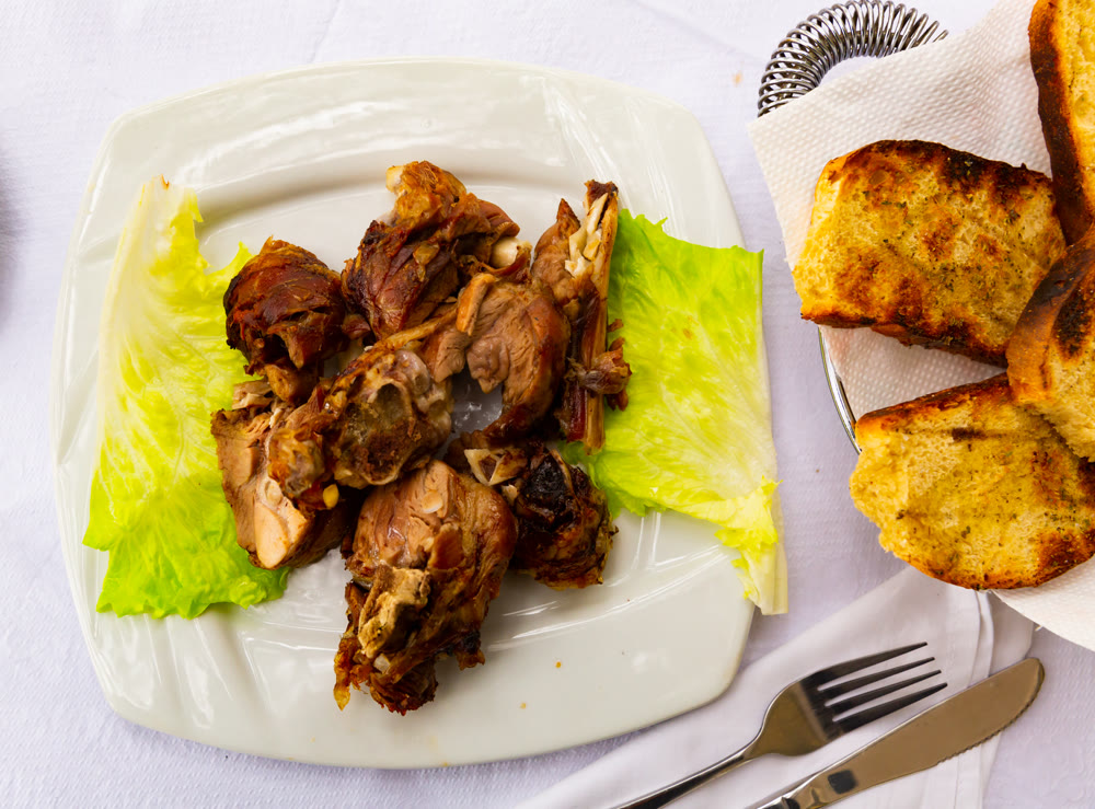 Lamb kebab served with onions on platter