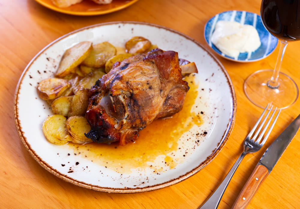 Stewed knuckle with potato served in a plate