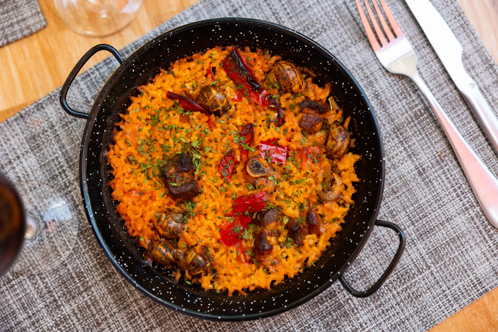 Traditional Valencian rice paella with snails