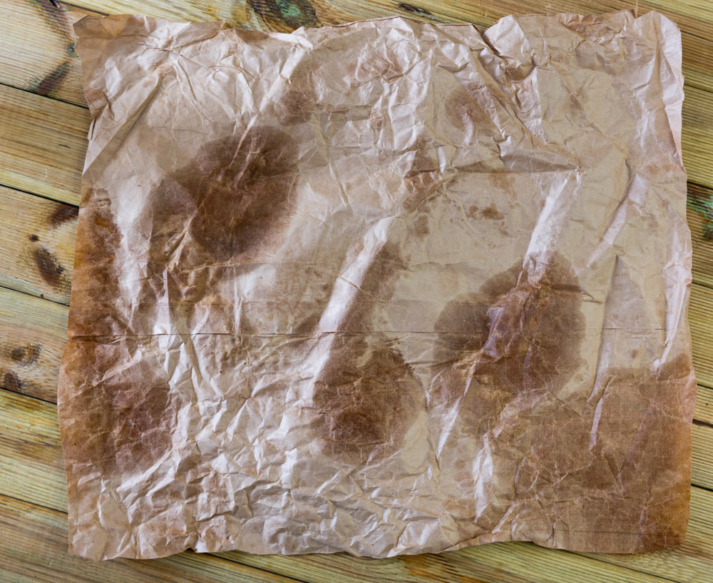 Vintage light brown crumpled paper sheet with stains