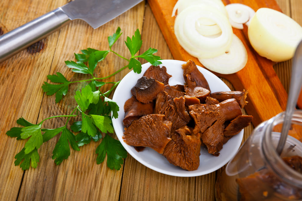 Marinated saffron milk cap mushrooms with onion and greens