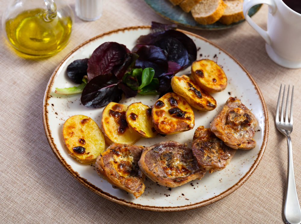 Delicious turkey with potatoes with leaf of fresh salad