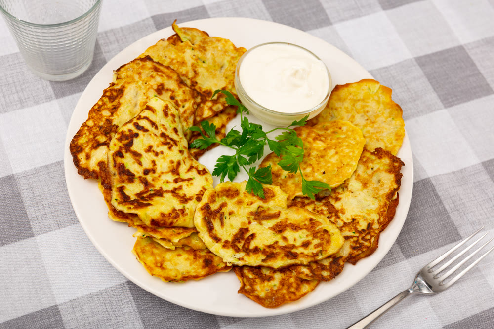 On plate are vegetable pancakes made from grated zucchini