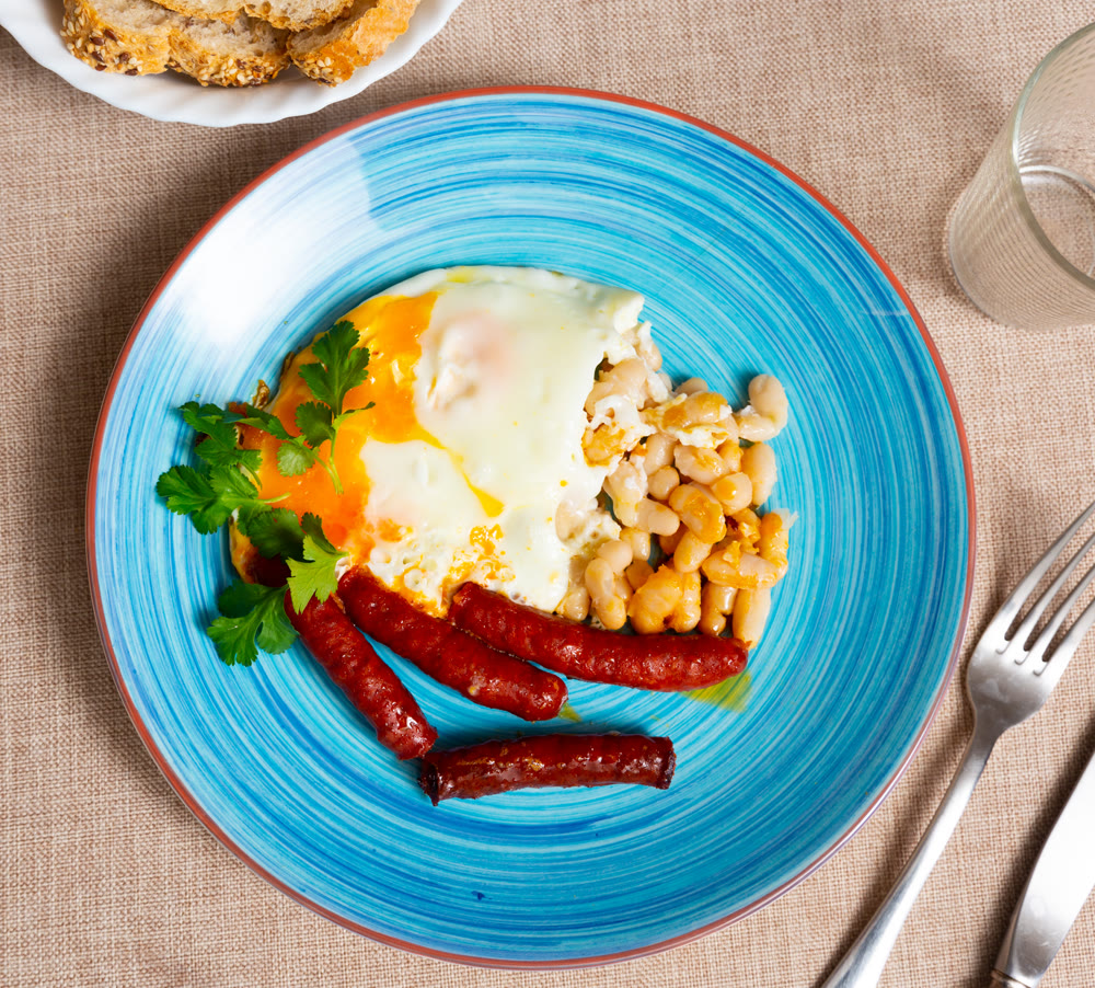Delicious chistorra sausages with scrambled eggs and beans